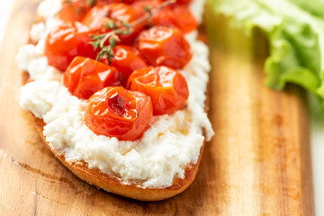 Sandwich with cherry tomatoes and cheese. Italian food, delicious breakfast.