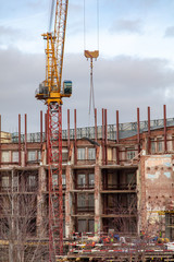 Fototapeta na wymiar Tower crane at a house construction site