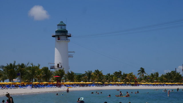 HARVEST CAYE BEACH, BELIZE 16. May 2017 - Wide shot of a lagoon for paddlers and a lighthouse on the beach of Harvest Caye. 