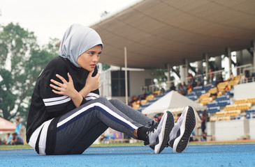 Sport and healthy lifestyle concept. Sportswoman stretching and having some warming up before running