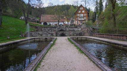 path between two ponds towards house