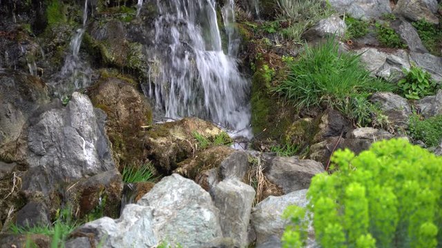 Flowing water stream, water drops and reflection