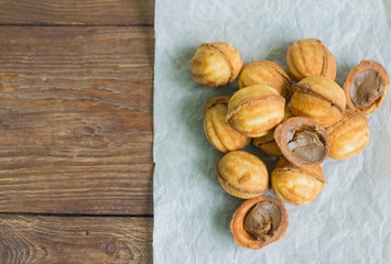 nuts idelicious homemade butter cookies with boiled condensed milk on a wooden backgroundn bowl on wooden table