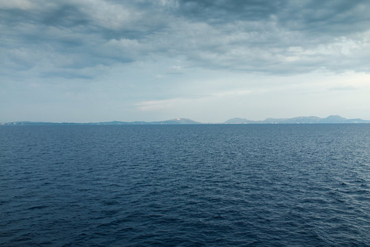 Seascape with sea horizon and almost clear deep blue sky 