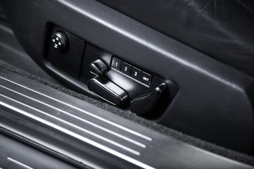 Obraz na płótnie Canvas Control buttons on black car seat