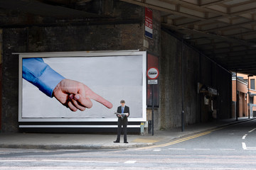 Billboard pointing at businessman