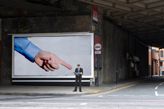 Billboard pointing at businessman