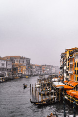 Fototapeta premium Venice / Italy 19 february 2019 :view of the Canal in Venice from Rialto bridge,gondolas are crossing the river and people enjoy their winter vacations