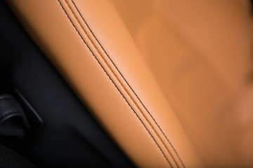 Close up of stitching on brown leather seat