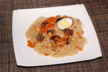 Rice with meat, carrot, vegetables and eggs on the top, also called as polaw, plov