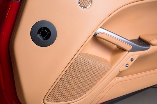 Close up of speaker in brown leather car interior