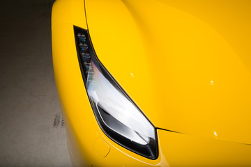 Headlight on yellow car exterior