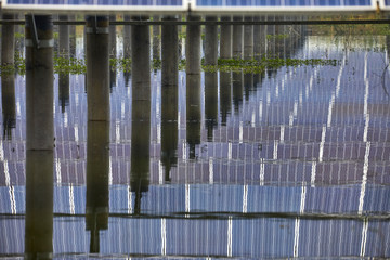 Solar photovoltaic panel with reflection on the lake