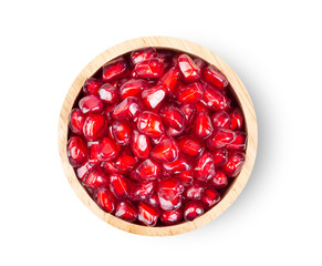 Pomegranate seeds in wood bowl isolated on white background. full depth of field