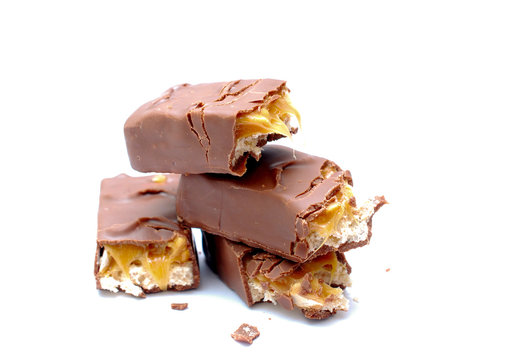 chocolate and nuts energy bar on white close up photography image