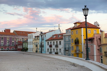 Fototapeta na wymiar View of a row of colorful houses near the National Pantheon in Lisbon, Portugal, at sunset