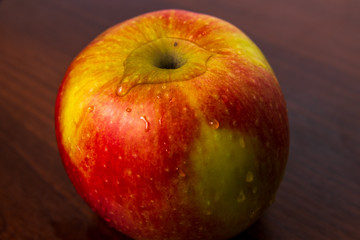 Healthy organic apple isolated on a dark wood background