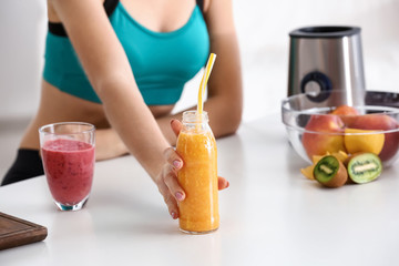 Young woman with healthy smoothie at home