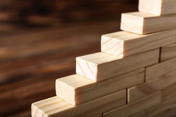 Stacked wooden blocks, closeup. Concept of career