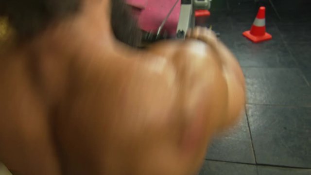 Man working out on rowing machine in gym  BMCC 2.5K resolution: 2400 x 1350