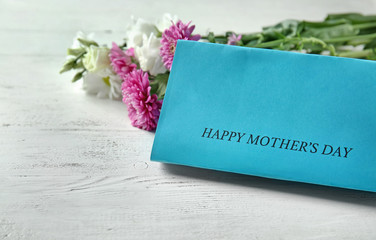 Greeting card for Mother's Day on white wooden background
