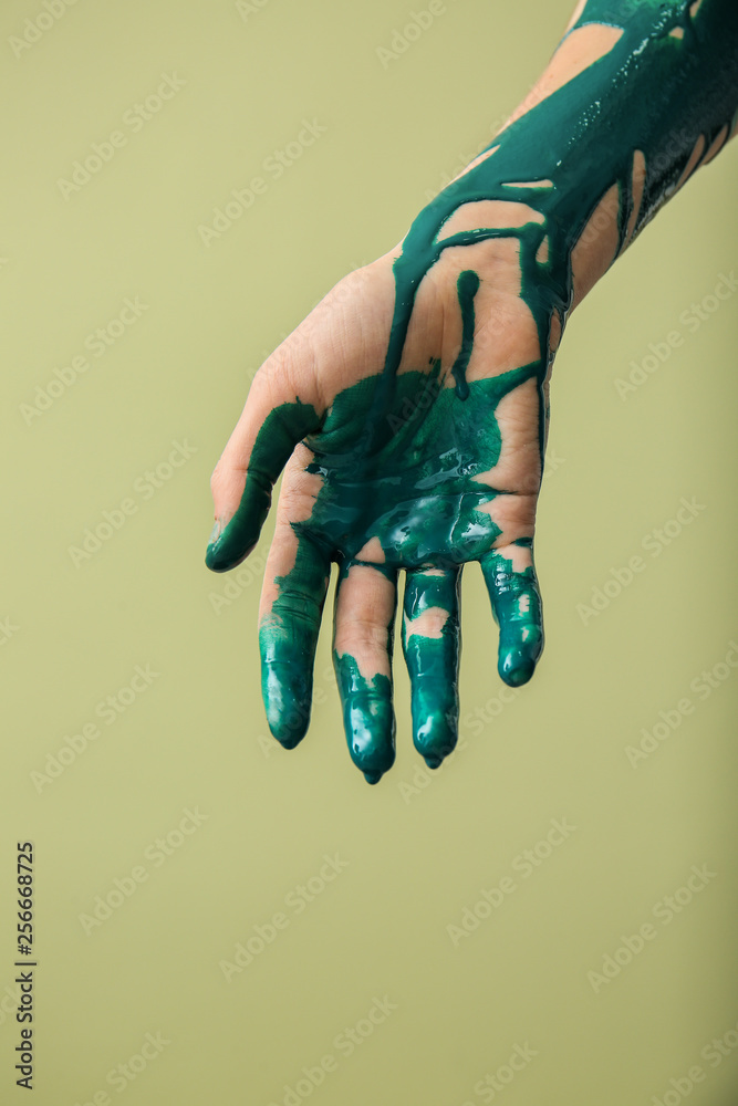 Wall mural Painted hand on color background