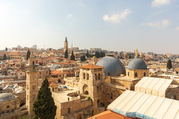 Fototapeta na wymiar Wide view from top on two domes and belfry of the Church of the Holy Sepulchre and Omar's mosque in Jerusalem