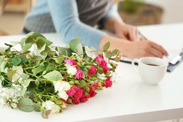 Bouquet of beautiful flowers on table of female florist