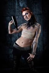 Young tattooed woman, one-eyed, bottle in hand