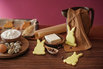 Easter cookies with ingredients on wooden table