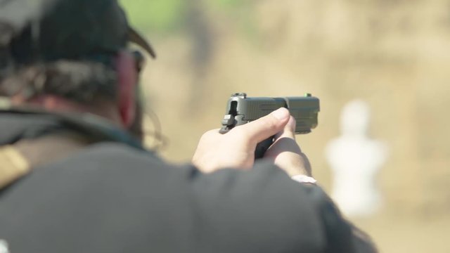Pistol being shot in 240fps at shooting range