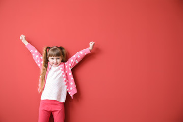 Happy little girl on color background