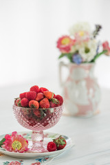 Strawberries in a pretty compote on a white background