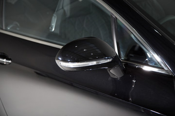 Close up of mirror on black car