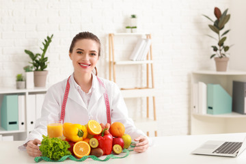 Portrait of female nutritionist with healthy products in her office