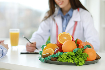 Tray with healthy products on nutritionist's table