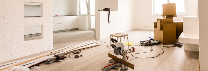 Interior of apartment with materials during on the renovation and construction ( remodel wall from gypsum plasterboard or drywall)