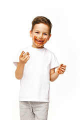 little boy with face and hands in chocolate 