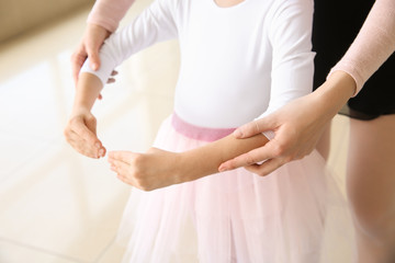 Obraz na płótnie Canvas Little ballerina training with coach in dance studio