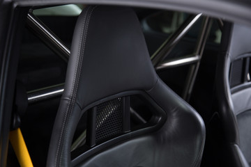 Obraz premium Black leather headrest on sports car seat
