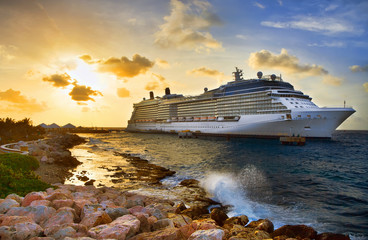 Cruise ship docked at port on sunset. 