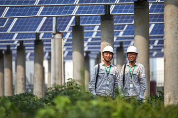 Asian engineer inspecting solar photovoltaic district
