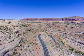 Fototapeta na wymiar Mesa and canyon landscape and Utah State Route 313 aerial view near Arches National Park, Moab, Utah, USA.