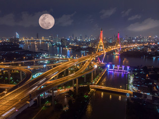 Fototapeta na wymiar Aerial Shot : beautiful night scene of Bhumibol Bridge, also known as the Industrial Ring Road Bridge, The bridge crosses the Chao Phraya River in Bangkok, Thailand.
