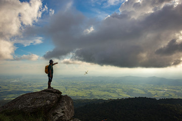 Man standing on top mountain and looking sunset.