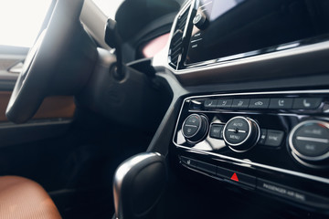Obraz na płótnie Canvas Air conditioning button inside a car. Climate control unit in the new car. Modern car interior details. Car detailing. Selective focus