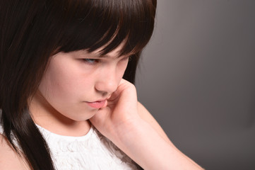 Close-up portrait of girl with dark hair posing