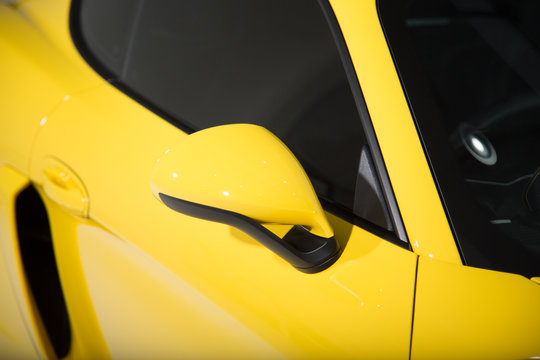 Close up of mirror on yellow sports car
