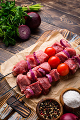 Raw shish kebab skewers  with tomatoes