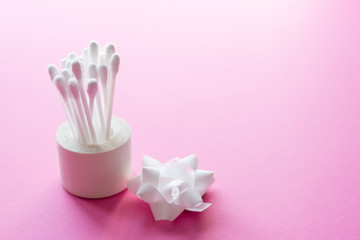 Close up of cotton buds on pink background. Cosmetic concept with copy space. Medicine and personal hygiene.place for text